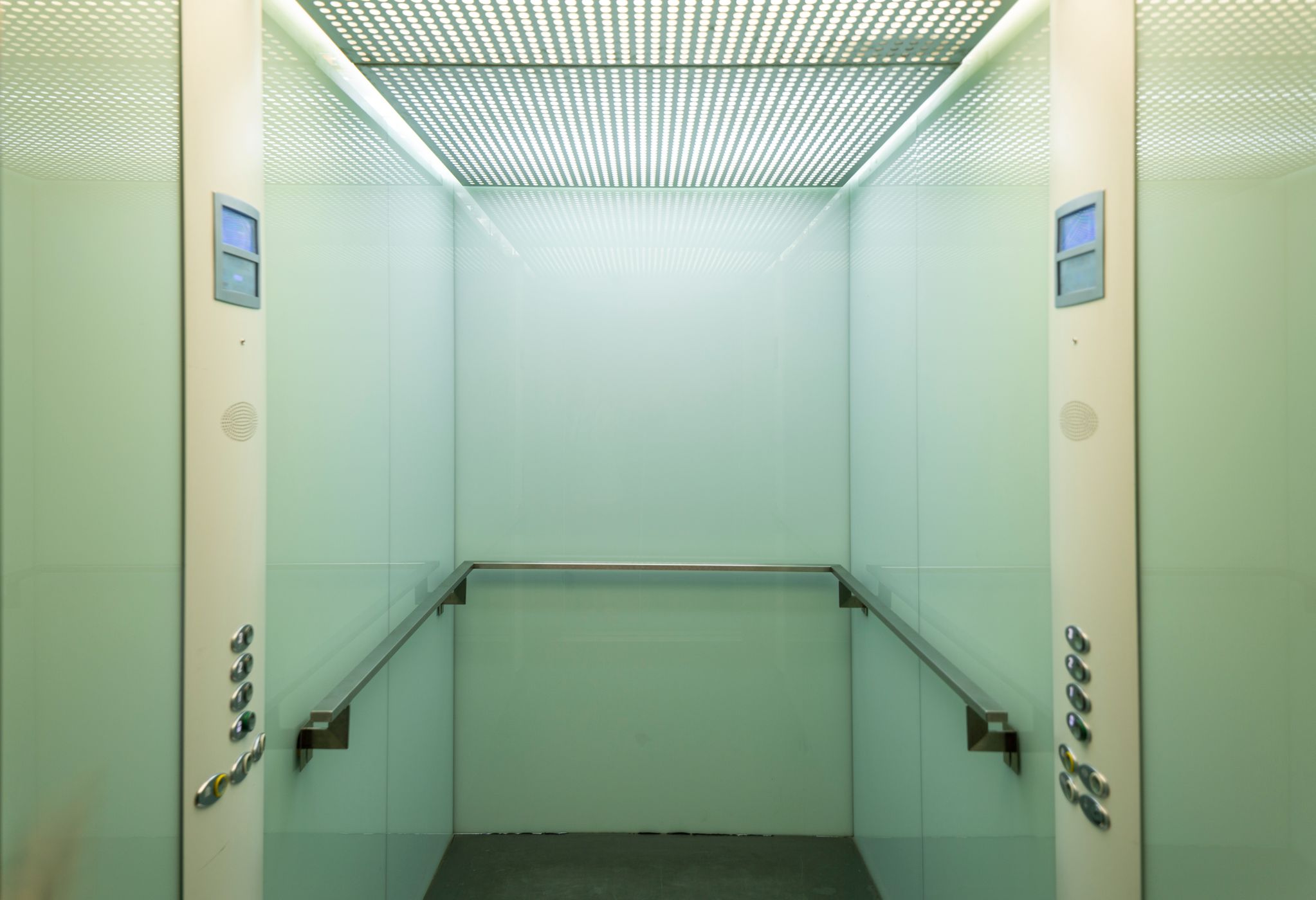 Modern elevator cab with polished metal doors and warm lighting